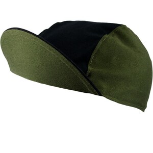 May include: A black and green cycling cap with a curved brim. The cap is made of a soft, breathable fabric.