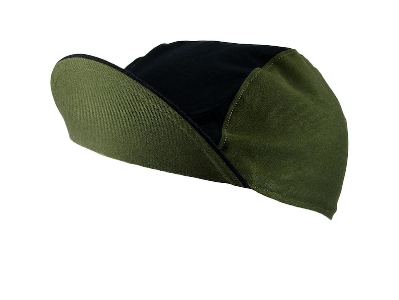 May include: A black and green cycling cap with a curved brim. The cap is made of a soft, breathable fabric.