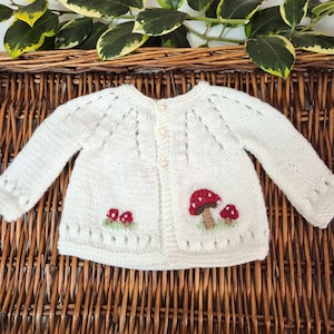 White Baby Cardigan with embroidered Toadstools. Hand Knit Woodland Jumper, Newborn Sweater