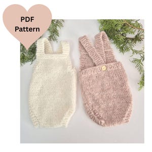 May include: Two knitted baby rompers, one cream and one dusty rose, are displayed. The dusty rose romper has a button closure. The image includes a heart-shaped graphic with the text "PDF Pattern". The rompers are made of a soft, textured yarn.
