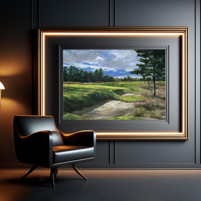 May include: A framed painting of a golf course with a green fairway, sand trap, and a red flag in the distance. The sky is cloudy and blue with a few white clouds. The painting is framed in a gold frame.