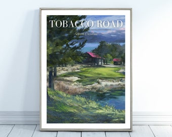 May include: A painting of a golf course with a green fairway, a pond, and a small building with a red roof. The painting is framed in a light wood frame and has the text "TOBACCO ROAD North Carolina" at the top.