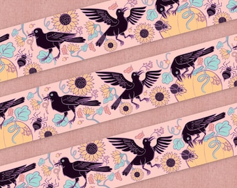 May include: A repeating pattern of black birds with outstretched wings, flying over a pink background with yellow sunflowers, green leaves, and orange pumpkins.
