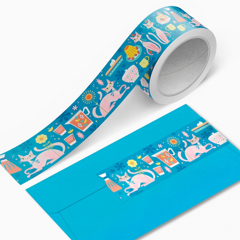 May include: A blue and white washi tape dispenser with a repeating pattern of pink cats, teacups, and flowers. The tape features a repeating pattern of pink cats, teacups, and flowers.