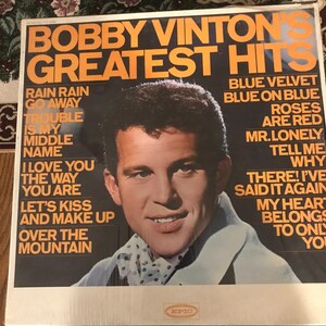 May include: A vintage vinyl record album titled "Bobby Vinton's Greatest Hits." The album cover features a portrait of Bobby Vinton with song titles like "Blue Velvet" and "Roses Are Red." The album is in its original packaging.