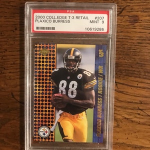 May include: A PSA graded football card featuring Plaxico Burress, a wide receiver for the Pittsburgh Steelers. The card is from the 2000 Coll.Edge T-3 Retail series and is graded a MINT 9. The card features a photo of Burress in his Steelers uniform, catching a football. The card number is #207.