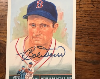 May include: A vintage baseball card featuring a portrait of Bobby Doerr, a former Major League Baseball player. The card is a watercolor illustration of Doerr wearing a red and white Boston Red Sox uniform. The card has a blue background and a green scoreboard with the text "RPC BATTER 123456789 NEX BALIKES OUTS".