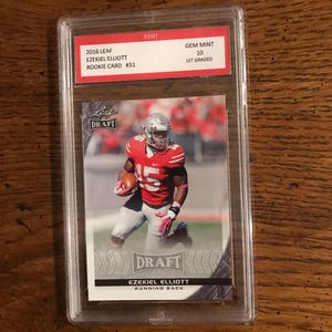 Cartão de futebol americano Ezekiel Elliott Leaf Rookie, nota 10 (conforme ilustrado) (edição original) (5437)