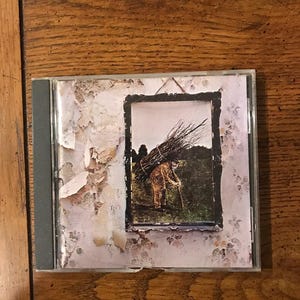 El estuche del CD de Led Zeppelin II está dañado y se envía sin cargo a EE. UU. (CD-1)
