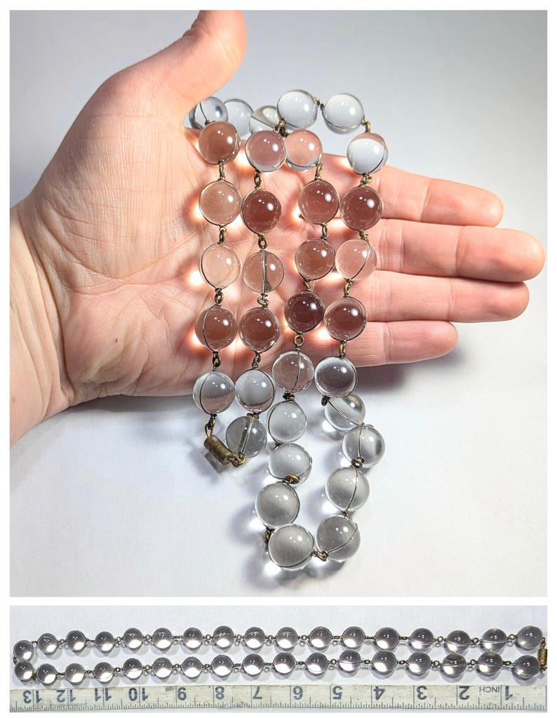 May include: A vintage glass bead necklace with alternating clear and light brown beads. The necklace is approximately 18 inches long and features a brass clasp.