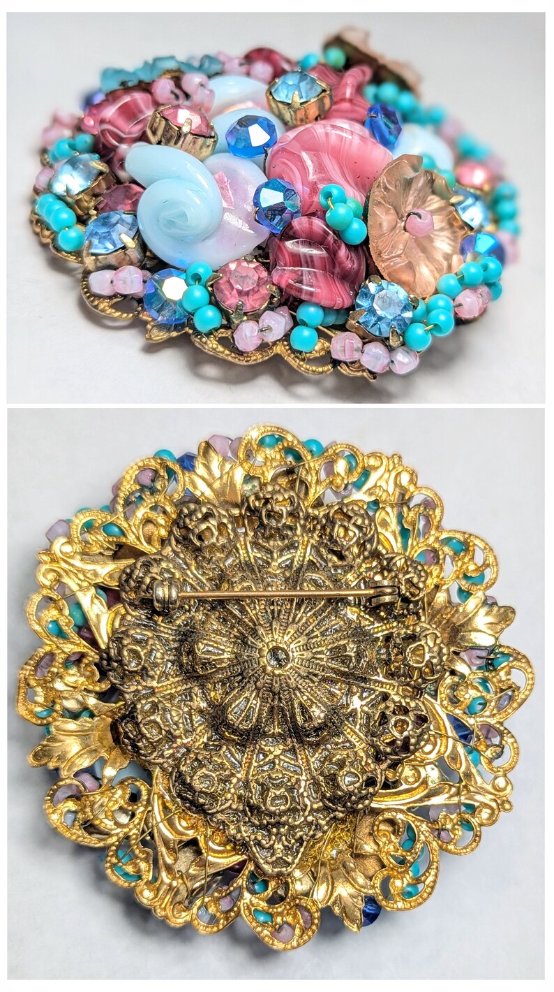 May include: A vintage brooch with a gold filigree design and a cluster of pink, blue, and turquoise beads and glass stones.
