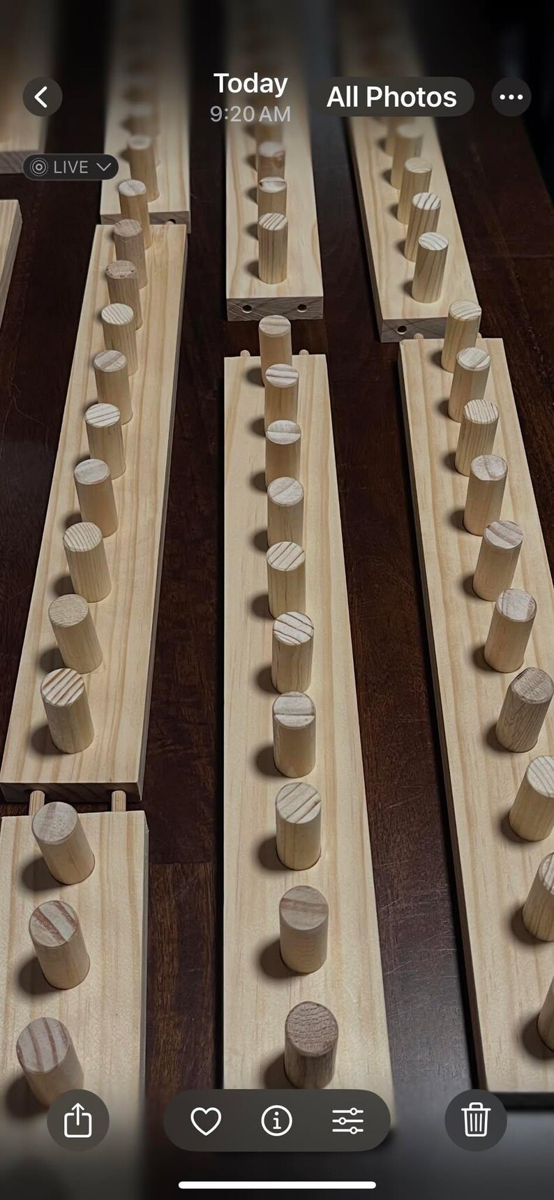 May include: A set of three wooden wall organizers with rows of dowels for hanging items. Each organizer has a light wood finish and is mounted on a wall.