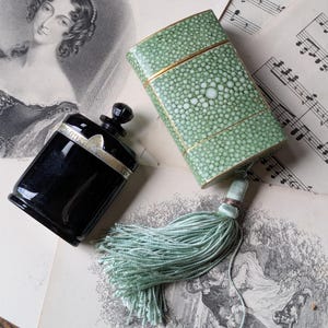 Caron Nuit de Noel perfume bottle in faux shagreen case with tassel