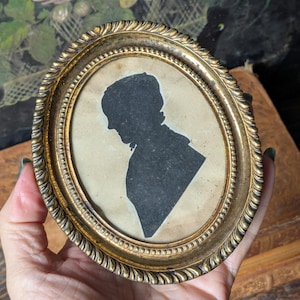 Antique 18th century silhouette of woman in pressed brass frame