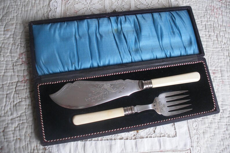 Antique bone handle fish servers in case