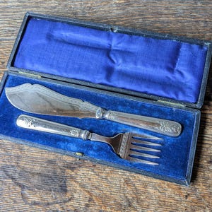 Antique cased fish servers with bow design