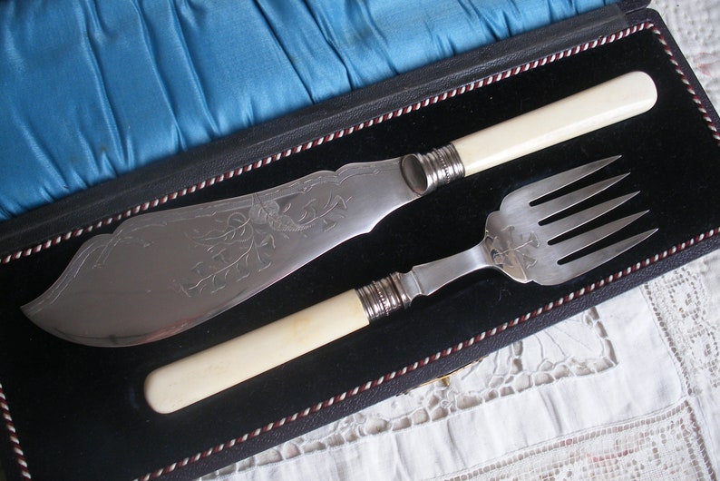 Antique bone handle fish servers in case