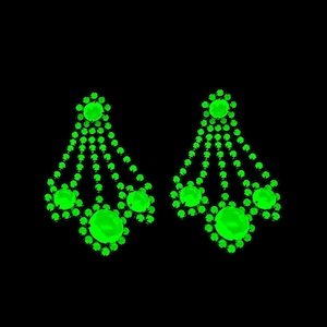 May include: A pair of dangle earrings with a cascading design of green rhinestones.