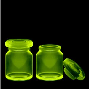 Collectible Uranium Glass Bottles With Lids Apothecary Jars Trinket Bottles ( 2 pieces )