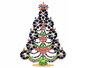 May include: A decorative Christmas tree ornament constructed from a metal frame encrusted with multi-coloured rhinestones, including deep purple, bright green, light pink, and clear crystals, standing on a small, circular gold-toned base.