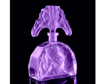 May include: A lavender-coloured perfume bottle with a detailed stopper and a sculpted design featuring figures. The bottle has a geometric shape with a rounded front. The background is black.
