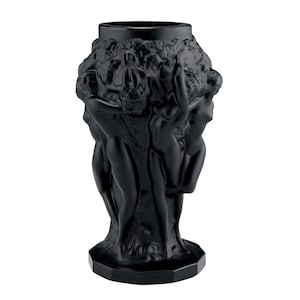 May include: A black glass vase with a sculpted design of figures surrounding a tree. The vase has a geometric base.