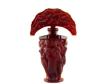 May include: A red glass perfume bottle with a sculpted stopper featuring a group of figures. The bottle is decorated with a relief design of figures.