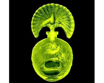 May include: A green glass bottle with a peacock design. The bottle is round and has a stopper in the shape of a peacock with its tail feathers spread out.