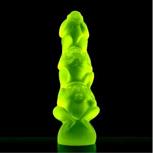May include: A green glass sculpture of three monkeys stacked on top of each other. The monkeys are in the "see no evil, hear no evil, speak no evil" pose.
