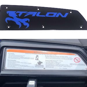 May include: Black metal plate with the word "TALON" in blue and a blue eagle claw graphic. The plate has several holes for mounting. Below is a warning label with safety instructions.