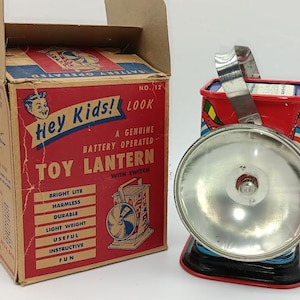 Vintage ohio art toy lantern in the original box. working #12 with morse code and ship flags.