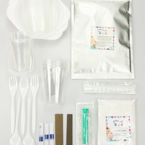 May include: A kit for making 3D hand casts with a white powder, a clear plastic syringe, two sanding blocks, three white plastic spoons, four white plastic forks, three clear plastic cups, three white plastic plates, and two packages of instructions. The kit includes the text "3D Hand-Cast Kit" and "Baby's First Hand-Cast"
