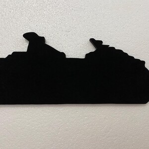 May include: Black silhouette of a cruise ship, a popular vacation destination for many.