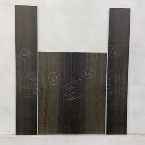 May include: A collection of dark brown wooden planks with visible wood grain. Each piece has a handwritten number "41" in a circle. The planks are arranged against a white background, suitable for woodworking or craft projects.