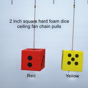 May include: Four 2 inch square hard foam dice in green, red, yellow, and blue colors hanging from chains. The dice are labeled as ceiling fan chain pulls.