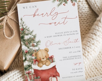 May include: A baby shower invitation with a Christmas theme. The invitation features a teddy bear in a red stocking, a Christmas tree, and the text "We can bearly wait." The invitation is on a white background.
