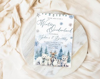 Peut inclure: Une carte d'invitation rectangulaire sur le thème Winter Onederland avec des flocons de neige bleus et blancs, un paysage de montagne enneigé et un groupe d'animaux arctiques illustrés, dont un ours polaire, un cerf, un pingouin et un renard.
