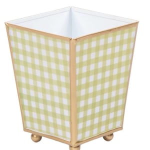 May include: A square decorative container with a light green and white gingham pattern. The container has gold trim and sits on three small gold ball feet. The interior is white.