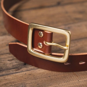 Brown English Bridle Leather Garrison Belt - 1.5 inch wide - detail - close up for solid brass buckle and teardrop holes and belt tip and brass Chicago screws