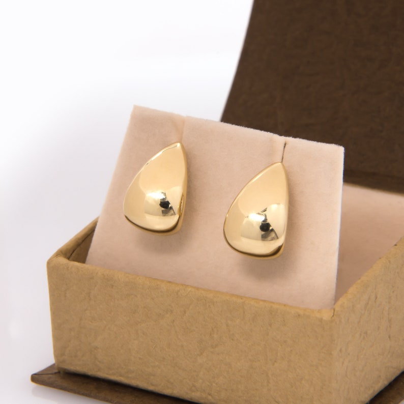 These gorgeous, handmade solid gold 14K Half Dome Earrings have a unique design 
These gold earrings are bold with a smooth, polished shape to catch the light!