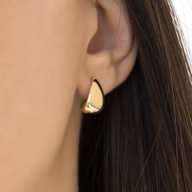 These gorgeous, handmade solid gold 14K Half Dome Earrings have a unique design 
These gold earrings are bold with a smooth, polished shape to catch the light!