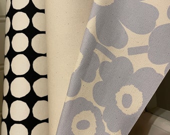 May include: Three fabric swatches, one with a black and white polka dot pattern, one with a solid white background, and one with a light blue floral pattern.