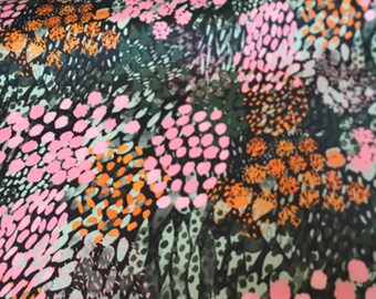 May include: Abstract fabric with a black background and a colorful pattern of pink, orange, and green. The pattern is made up of small dots, swirls, and lines.