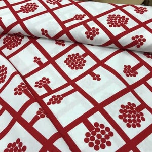May include: White fabric with a red geometric pattern of squares and circles. The circles are arranged in a cluster to form a tree shape.