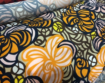 May include: A fabric with a floral pattern in shades of orange, pink, brown, and black. The flowers are stylized and have a retro feel.