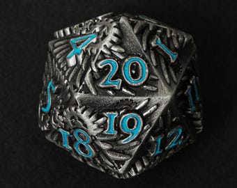 May include: A silver 20-sided die with blue numbers and a textured surface. The die is shaped like a dodecahedron and has a dragon design.
