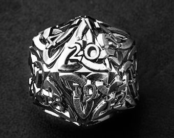 May include: A silver metal 20-sided die with intricate designs and numbers on each face.