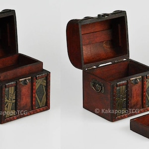 May include: Two wooden treasure chests with ornate metal accents and a hinged lid. The chests are open and have a brown interior. The chests are approximately 5 inches tall and 4 inches wide.