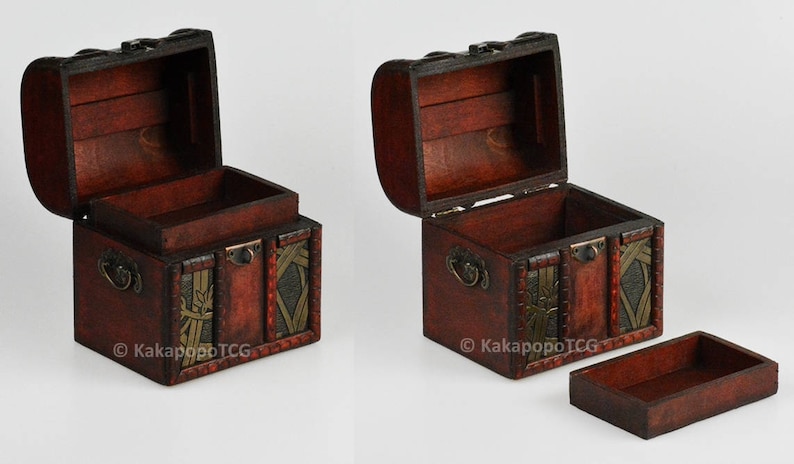 May include: Two wooden treasure chests with ornate metal accents and a hinged lid. The chests are open and have a brown interior. The chests are approximately 5 inches tall and 4 inches wide.