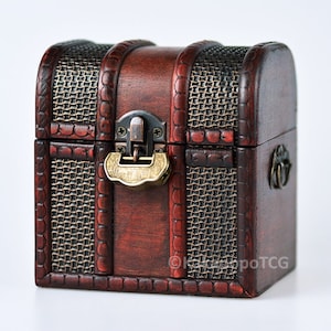 May include: A small, wooden treasure chest with a brown stain and a woven pattern on the front and sides. The chest has a brass latch and a metal handle.